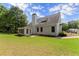 Expansive backyard featuring a well-maintained lawn, mature trees, and a screened porch for outdoor enjoyment at 3040 Larkspur Ct, Cumming, GA 30041