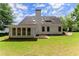 Well-manicured backyard with lush green lawn and white two-story home with a chimney at 3040 Larkspur Ct, Cumming, GA 30041