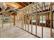 Unfinished basement with exposed wooden beams, concrete floor, and natural light from the windows at 3040 Larkspur Ct, Cumming, GA 30041