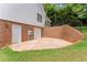 Spacious basement entrance featuring double doors, a brick retaining wall, and access to the backyard at 3040 Larkspur Ct, Cumming, GA 30041