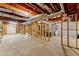 Unfinished basement with exposed wooden beams, concrete floor, and utilities along the wall at 3040 Larkspur Ct, Cumming, GA 30041
