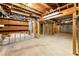 Unfinished basement with exposed wooden beams, concrete floor, and room for customization at 3040 Larkspur Ct, Cumming, GA 30041