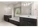 Bright bathroom features a double sink vanity, a soaking tub, and a large window for natural light at 3040 Larkspur Ct, Cumming, GA 30041