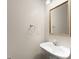 Bright half bathroom with a pedestal sink, white cabinets, and a decorative mirror with silver and gold trim at 3040 Larkspur Ct, Cumming, GA 30041