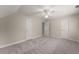Bedroom featuring neutral walls, plush carpet, ceiling fan, and doors for natural light at 3040 Larkspur Ct, Cumming, GA 30041