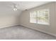 Bedroom featuring neutral walls, plush carpet, ceiling fan, and a window with natural light at 3040 Larkspur Ct, Cumming, GA 30041