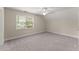 Bedroom featuring neutral walls, plush carpet, ceiling fan, and a window with natural light at 3040 Larkspur Ct, Cumming, GA 30041