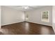 Inviting bedroom with hardwood floors, natural light from large windows, and a view of the outdoors, providing a serene setting at 3040 Larkspur Ct, Cumming, GA 30041