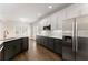 Modern kitchen with stainless steel refrigerator, hardwood floors, and a view of white subway tile backsplash at 3040 Larkspur Ct, Cumming, GA 30041