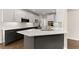 Kitchen with two-tone cabinets, quartz countertops, stainless steel appliances, and a breakfast bar at 3040 Larkspur Ct, Cumming, GA 30041