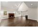 Spacious living room features a brick fireplace, skylights, hardwood floors, and connects seamlessly to the modern kitchen at 3040 Larkspur Ct, Cumming, GA 30041