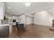 Open-concept living room with hardwood floors, a fireplace, and ample natural light, creating a warm and inviting space at 3040 Larkspur Ct, Cumming, GA 30041