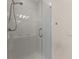 Clean shower with glass door and updated shower head with white tiled walls and built-in seat at 3040 Larkspur Ct, Cumming, GA 30041
