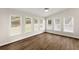 Bright sunroom with multiple windows, hardwood floors, and natural light, perfect for relaxation or entertaining guests at 3040 Larkspur Ct, Cumming, GA 30041