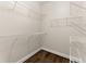 Walk-in closet with custom built-in wire shelving and hardwood floors for convenient storage at 3040 Larkspur Ct, Cumming, GA 30041