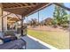 Relaxing covered back patio with grill and outdoor seating area overlooking a well-maintained lawn at 3080 Westpoint Cir, Snellville, GA 30078