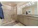 Modern bathroom featuring a glass shower and double vanity with granite countertops at 3080 Westpoint Cir, Snellville, GA 30078