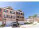 Charming two-story brick townhome with an attached garage and neatly landscaped front yard at 3080 Westpoint Cir, Snellville, GA 30078