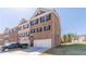Newly built two-story townhome with a brick facade, attached garage, and well-manicured lawn at 3080 Westpoint Cir, Snellville, GA 30078