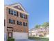 Charming brick townhome with an attached garage and dark shutters, offering a classic and inviting curb appeal at 3080 Westpoint Cir, Snellville, GA 30078