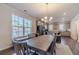 Open concept kitchen features gray cabinets, stainless steel appliances, and a large dining table with bench seating at 3080 Westpoint Cir, Snellville, GA 30078