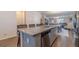 Open-concept kitchen featuring a large island with seating and ample counter space, perfect for cooking and socializing at 3080 Westpoint Cir, Snellville, GA 30078