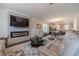 Comfortable living room area featuring an electric fireplace, ceiling fan, and open view to dining area at 3080 Westpoint Cir, Snellville, GA 30078