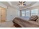 The main bedroom suite features plush carpet, lots of windows, a ceiling fan, and multiple closets at 3080 Westpoint Cir, Snellville, GA 30078