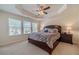 Spacious bedroom features plush carpet, large windows, ceiling fan and a comfortable king-size bed at 3080 Westpoint Cir, Snellville, GA 30078