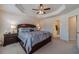 Spacious main bedroom features plush carpet, large windows, ceiling fan and an attached bathroom at 3080 Westpoint Cir, Snellville, GA 30078