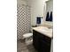 This bathroom features a patterned shower curtain, vanity, and mirror at 409 Ruths Blvd, Woodstock, GA 30188