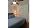 Bedroom with ceiling fan, lamp, and a window at 409 Ruths Blvd, Woodstock, GA 30188