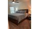 Comfortable bedroom with wooden bed frame and a ceiling fan at 409 Ruths Blvd, Woodstock, GA 30188