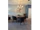 Dining area with a round table set, modern chandelier, and neutral wall colors at 409 Ruths Blvd, Woodstock, GA 30188