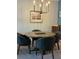 Modern dining area with a round table, four chairs, and a stylish chandelier at 409 Ruths Blvd, Woodstock, GA 30188