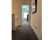 Hallway leading to a bedroom with carpet flooring, and neutral-toned walls at 409 Ruths Blvd, Woodstock, GA 30188