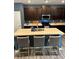 Stylish kitchen with a large center island, modern lighting, and dark cabinets provides ample counter space at 409 Ruths Blvd, Woodstock, GA 30188
