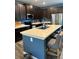 Modern kitchen with stainless steel appliances, dark cabinets, and a large island with seating at 409 Ruths Blvd, Woodstock, GA 30188