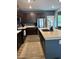 Spacious kitchen features stainless steel appliances, dark wood cabinets, and a kitchen island at 409 Ruths Blvd, Woodstock, GA 30188