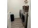 Modern laundry room with stainless steel washer and dryer set at 409 Ruths Blvd, Woodstock, GA 30188