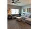 Comfortable living room with a large sectional sofa and a ceiling fan at 409 Ruths Blvd, Woodstock, GA 30188