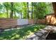 Backyard featuring artificial turf, stone pavers, and a wooden fence, perfect for outdoor relaxation and entertaining at 845 Lake Hollow Sw Blvd, Marietta, GA 30064