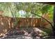 Backyard area enclosed by a wood fence features trees and mulch at 845 Lake Hollow Sw Blvd, Marietta, GA 30064