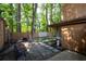 Backyard oasis featuring artificial turf, stone pavers, a wooden fence, and a fire pit for outdoor gatherings at 845 Lake Hollow Sw Blvd, Marietta, GA 30064