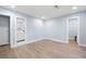 Light-filled bedroom with wood-look floors and access to an ensuite bathroom and closet at 845 Lake Hollow Sw Blvd, Marietta, GA 30064