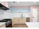 Modern kitchen with stainless steel appliances, white subway tile backsplash and light wood cabinets at 845 Lake Hollow Sw Blvd, Marietta, GA 30064