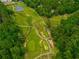 Aerial view of a beautiful golf course community with mature trees and ponds at 110 Fairway Ridge Dr, Johns Creek, GA 30022