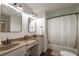 Cozy bathroom featuring dual vanity sinks, a bathtub/shower combination, and updated fixtures at 110 Fairway Ridge Dr, Johns Creek, GA 30022