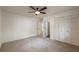 Spacious bedroom with neutral carpet, white walls, white closet doors and a window at 110 Fairway Ridge Dr, Johns Creek, GA 30022