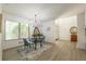 Bright dining area with a glass table, modern chandelier, and large window at 110 Fairway Ridge Dr, Johns Creek, GA 30022